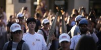 BTS star Jin and a garbage collector are among those carrying the Olympic torch through Paris
