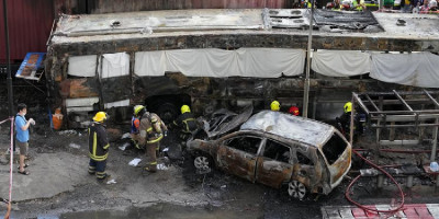 Freight train hits bus in Thailand rail crossing, killing eight people